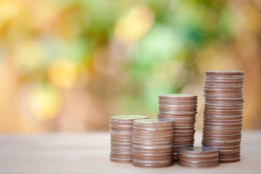 Money stacking of coins, saving money, new house, life insurance, new things, new life, isolated on bokeh background.
