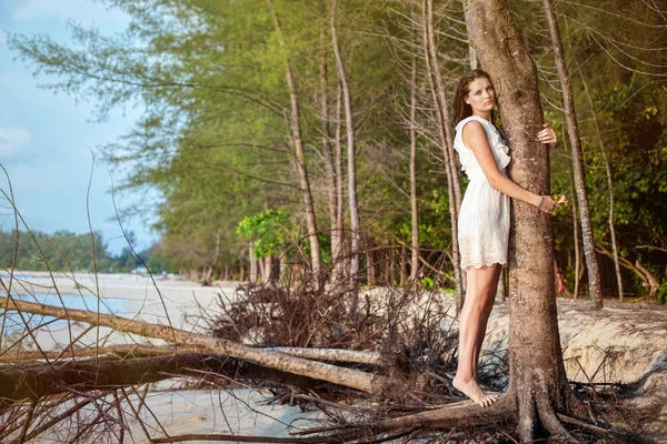 Woman on tropical beach on sunset — Stock Photo, Image