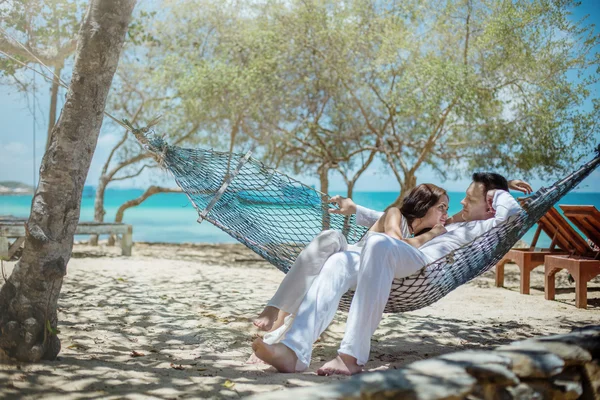 Love couple in a hammock at the beach Royalty Free Stock Images