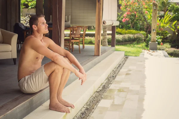 Man sitting on his luxury villa — Stock Photo, Image