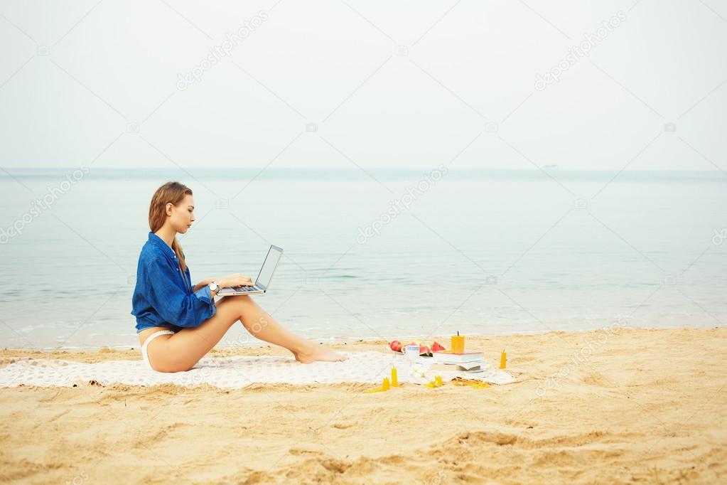 business woman working on the beach