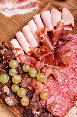 Cold meat plate, slices prosciutto, ham,beef jerky, sausage clipart