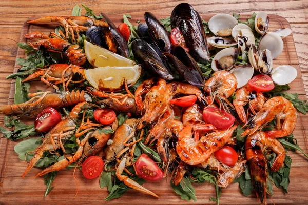 Fresh mussels, crayfish, shrimp decorated with arugula, tomatoes