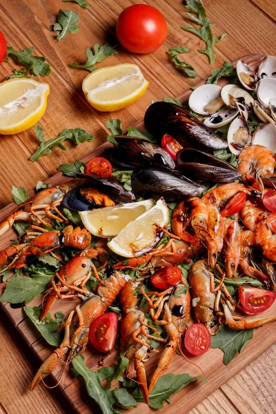 Fresh mussels, crayfish, shrimp decorated with arugula, tomatoes