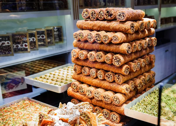 Eastern sweets in a wide range, baklava, Turkish delight with almond, cashew and pistachio nuts on plates — Stock Photo, Image