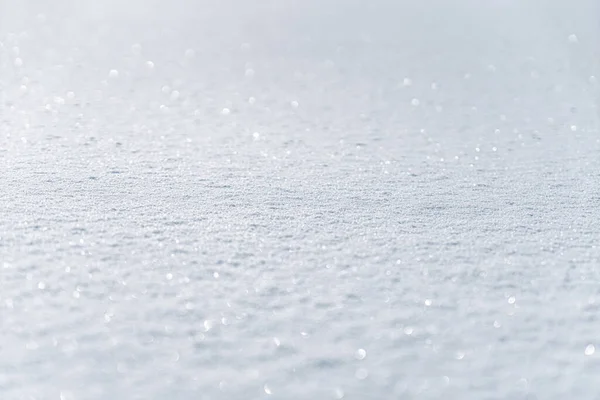 Winter snow. Snow texture with bokeh, light, selective focus. Snowy white texture. Snowflakes