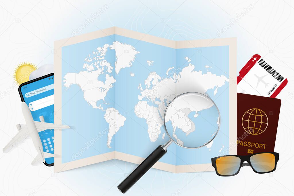 Travel destination Vietnam, tourism mockup with travel equipment and world map with magnifying glass on a Vietnam.