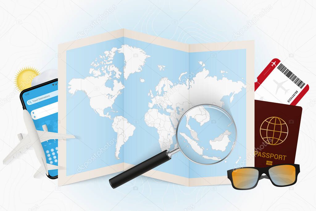 Travel destination Malaysia, tourism mockup with travel equipment and world map with magnifying glass on a Malaysia.