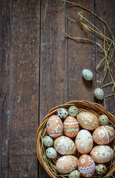 Easter eggs in the nest on rustic wooden background — Stock Photo, Image