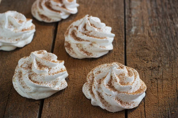 White meringue on a dark wooden background retro — Stock Photo, Image