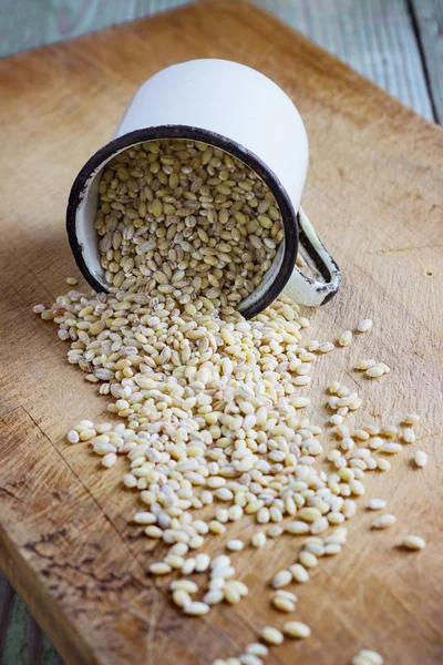 pearl barley on a wooden background