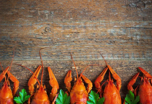 Boiled crayfish on a wooden background. — Stock Image Boiled crayfish on a wooden background. Royalty Free Stock Images