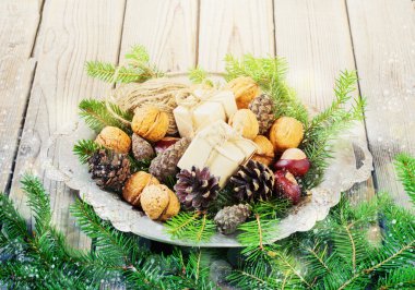 toys for the Christmas   tree and pine cones in a metal bowl, on old wooden background  new Year
