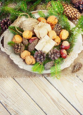 toys for the Christmas   tree and pine cones in a metal bowl, on old wooden background  new Year