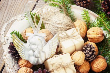 toys for the Christmas   tree and pine cones in a metal bowl, on old wooden background  new Year