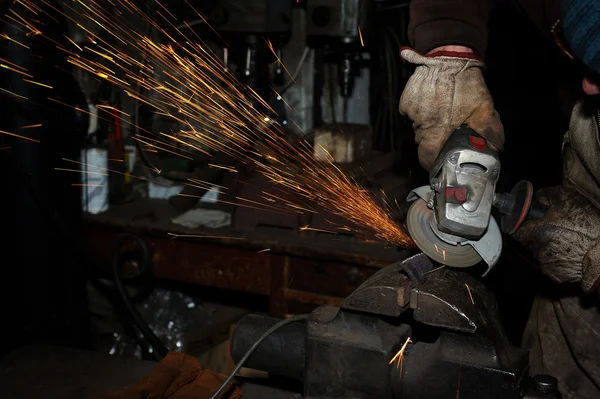 Angle grinder cutting steel with sparks