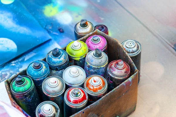 Used aerosol spray paint in cans in carton