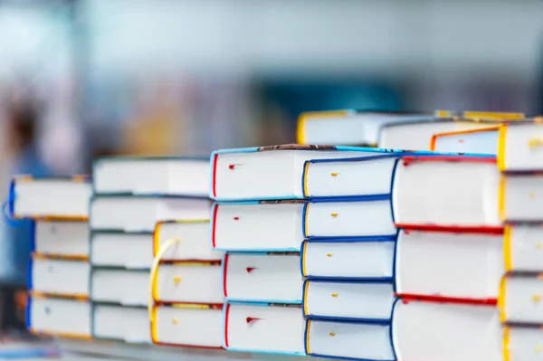 Stack of new books on the table. Books on the forum of manufacturers of printed products.