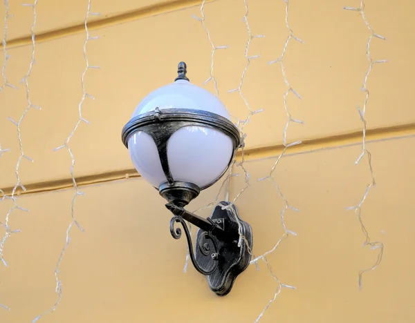 Old lamp lantern on the stone wall. — Stock Photo, Image