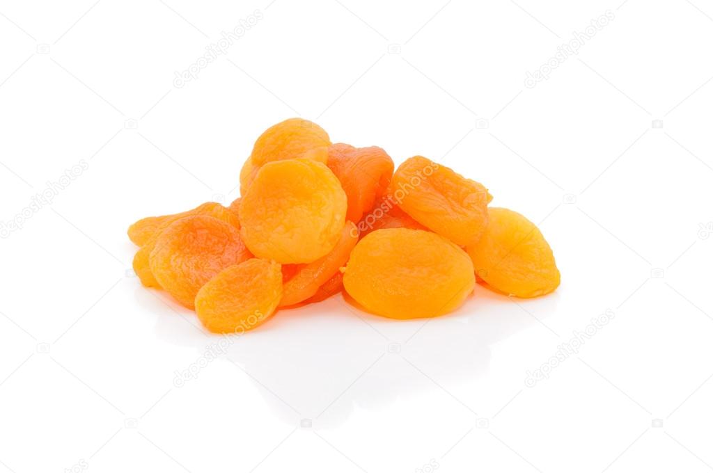 A heap of dried apricots on a white background with a light shad