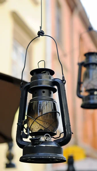 Kerosene lamp on the background of the old house, the old street — Stock Photo, Image