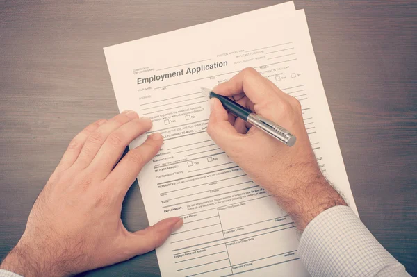 Man filling a job application form — Stock Photo, Image