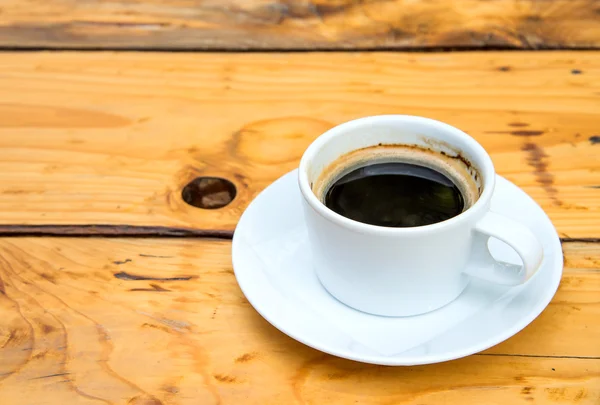 White coffee cup on wooden floor. — Stock Photo, Image