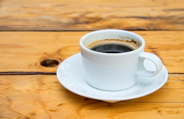 White coffee cup on wooden floor. — Stock Photo, Image
