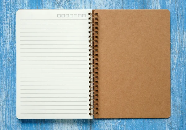 White and Brown notebook on blue wooden floor. — Stock Photo, Image