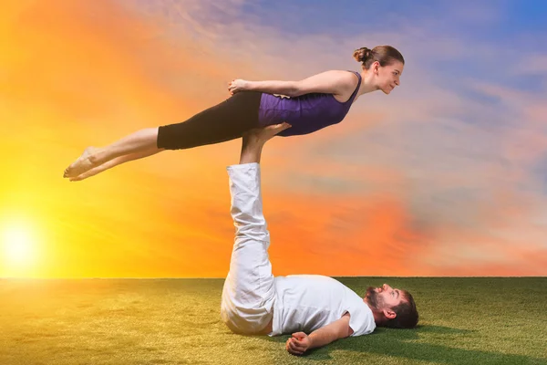 The two people doing yoga exercises