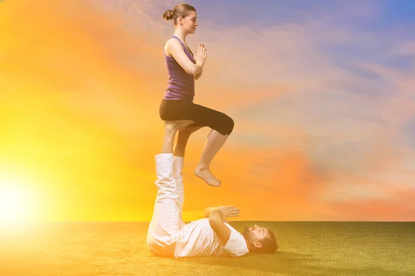 The two people doing yoga exercises — Stock Photo, Image