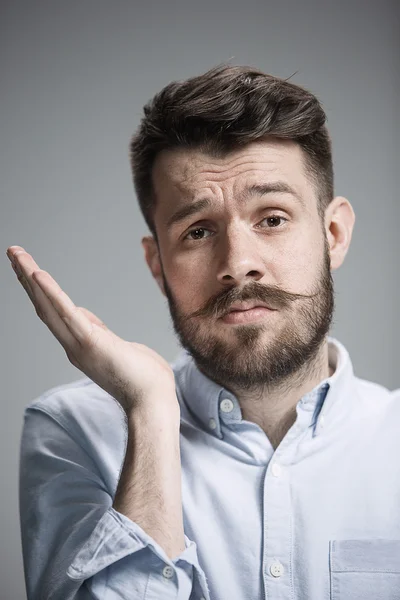 Man is looking bored. Over gray background — Stock Photo, Image