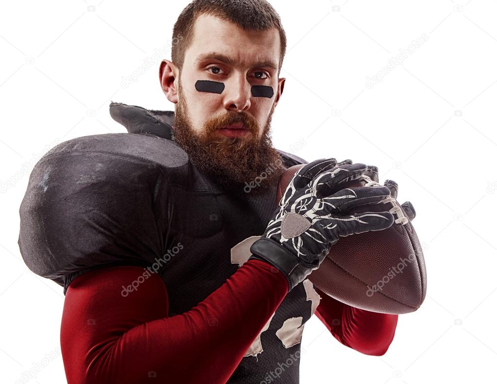 American football player posing with ball on white background