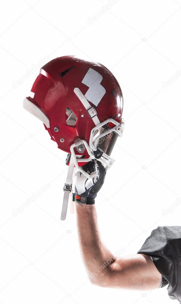 The hand of american football player with helmet on white background