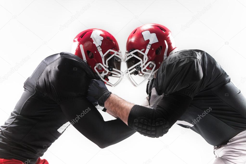 The two american football players fighting on white background