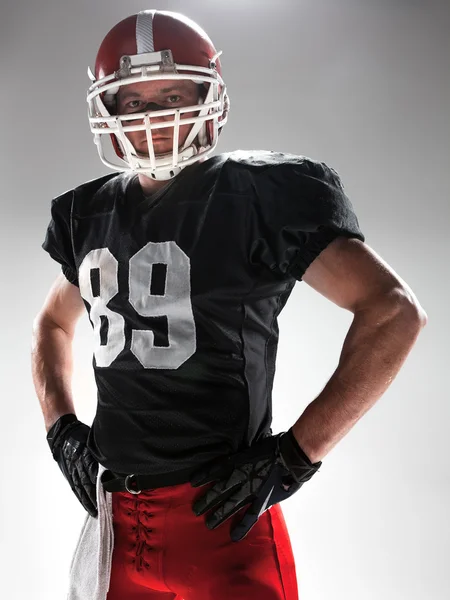 American Football-Spieler posiert mit Ball auf weißem Hintergrund — Stockfoto