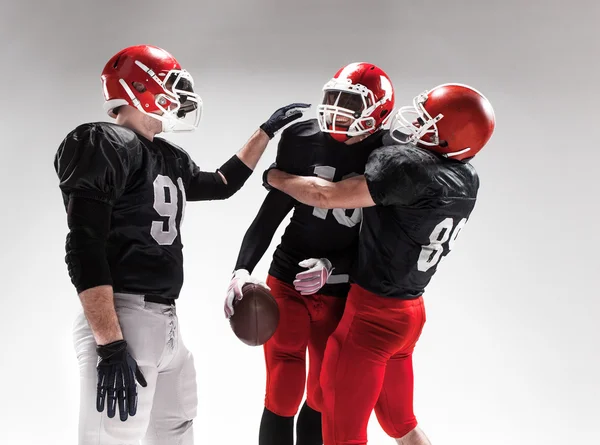 The three american football players posing on white background — Stock Photo, Image
