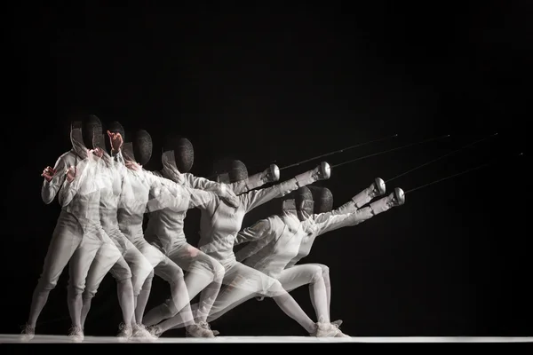 Full-length portrait of woman wearing white fencing costume  on black — Stock Photo, Image