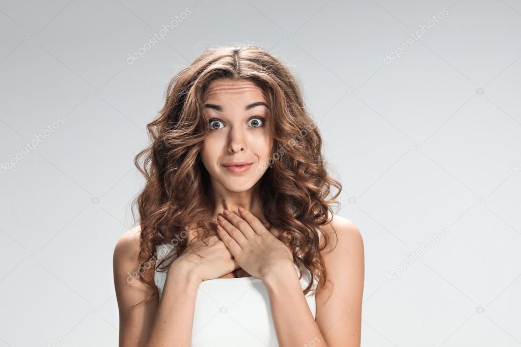 Portrait of young woman with shocked facial expression