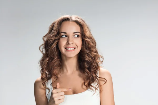 The happy woman on gray background — Stock Photo, Image