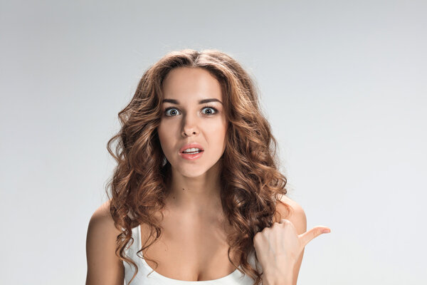 The happy woman on gray background