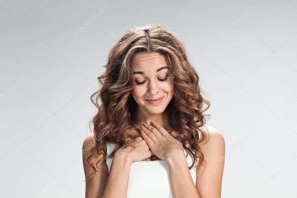Woman is looking imploring over gray background
