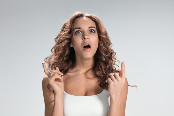 Portrait of young woman with shocked facial expression