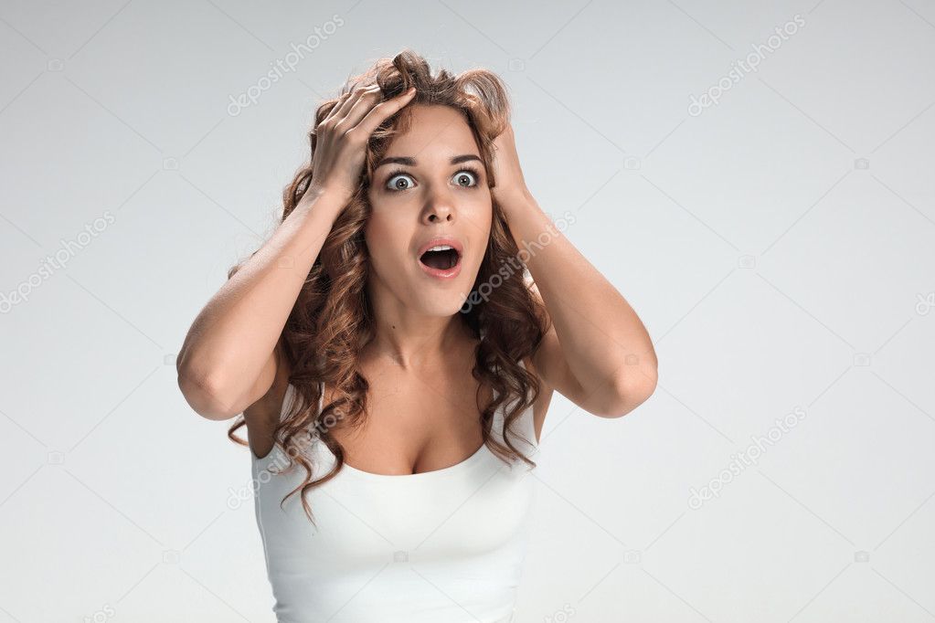 Portrait of young woman with shocked facial expression