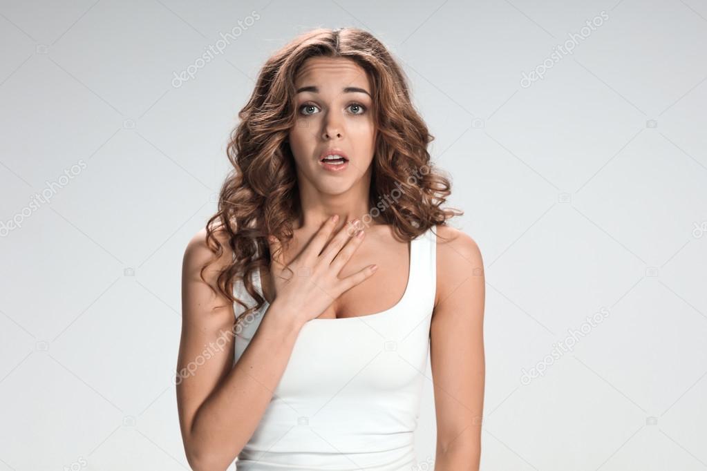 Woman is looking imploring over gray background