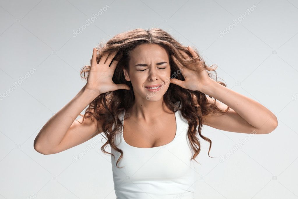 Portrait of young woman with shocked facial expression