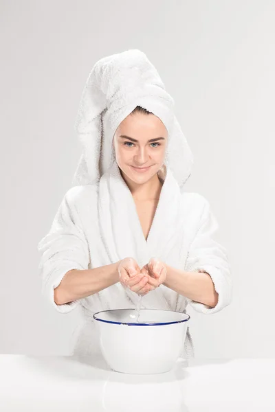 Frau putzt Gesicht im Badezimmer — Stockfoto