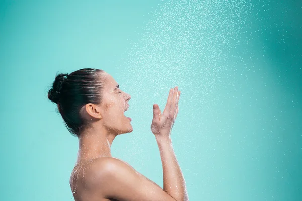 Woman enjoying water in the shower under a jet — Stock Photo, Image