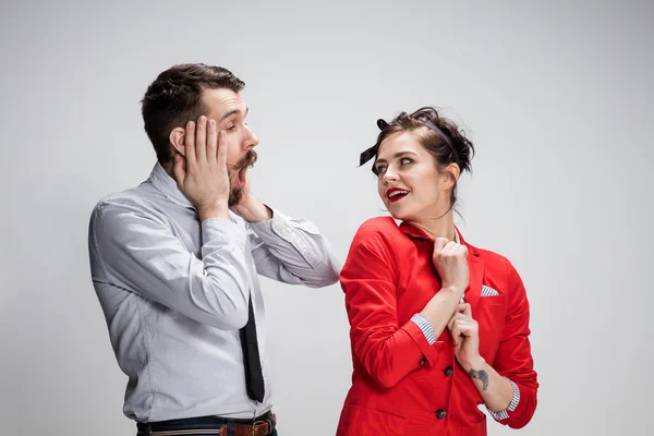 El hombre y la mujer de negocios que se comunican sobre un fondo gris —  Fotos de Stock