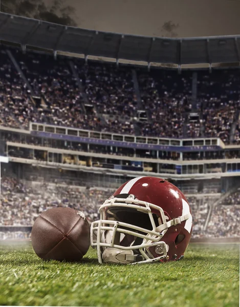 The ball of american football players and helmet on stadium background — Stock Photo, Image